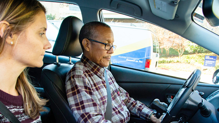 A dual-control training car with the instructor in the passenger seat
