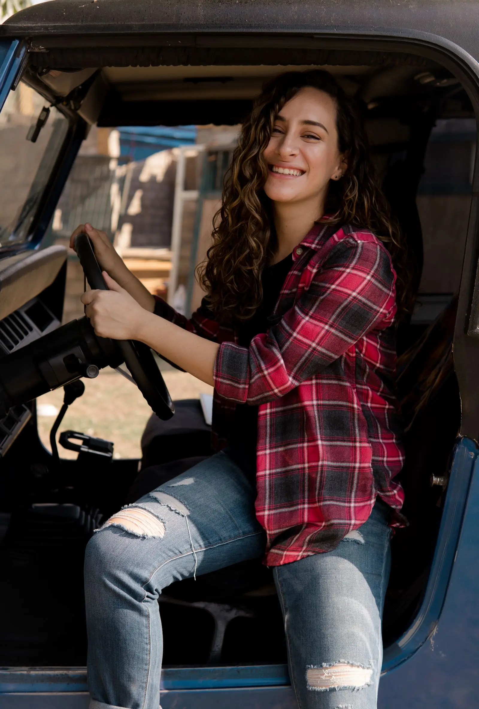 A relaxed learner smiling from the driver’s seat