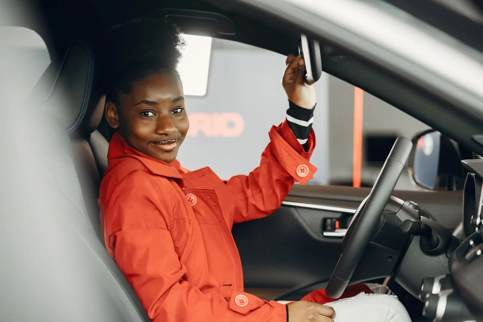 A confident learner checking the mirror from the driver’s seat