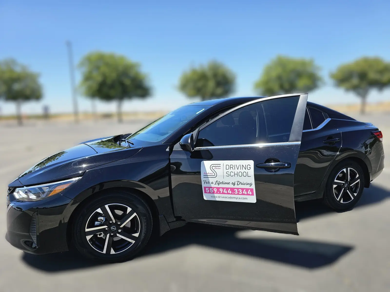 The Drive Academy Nissan with its magnetic door sign and phone number