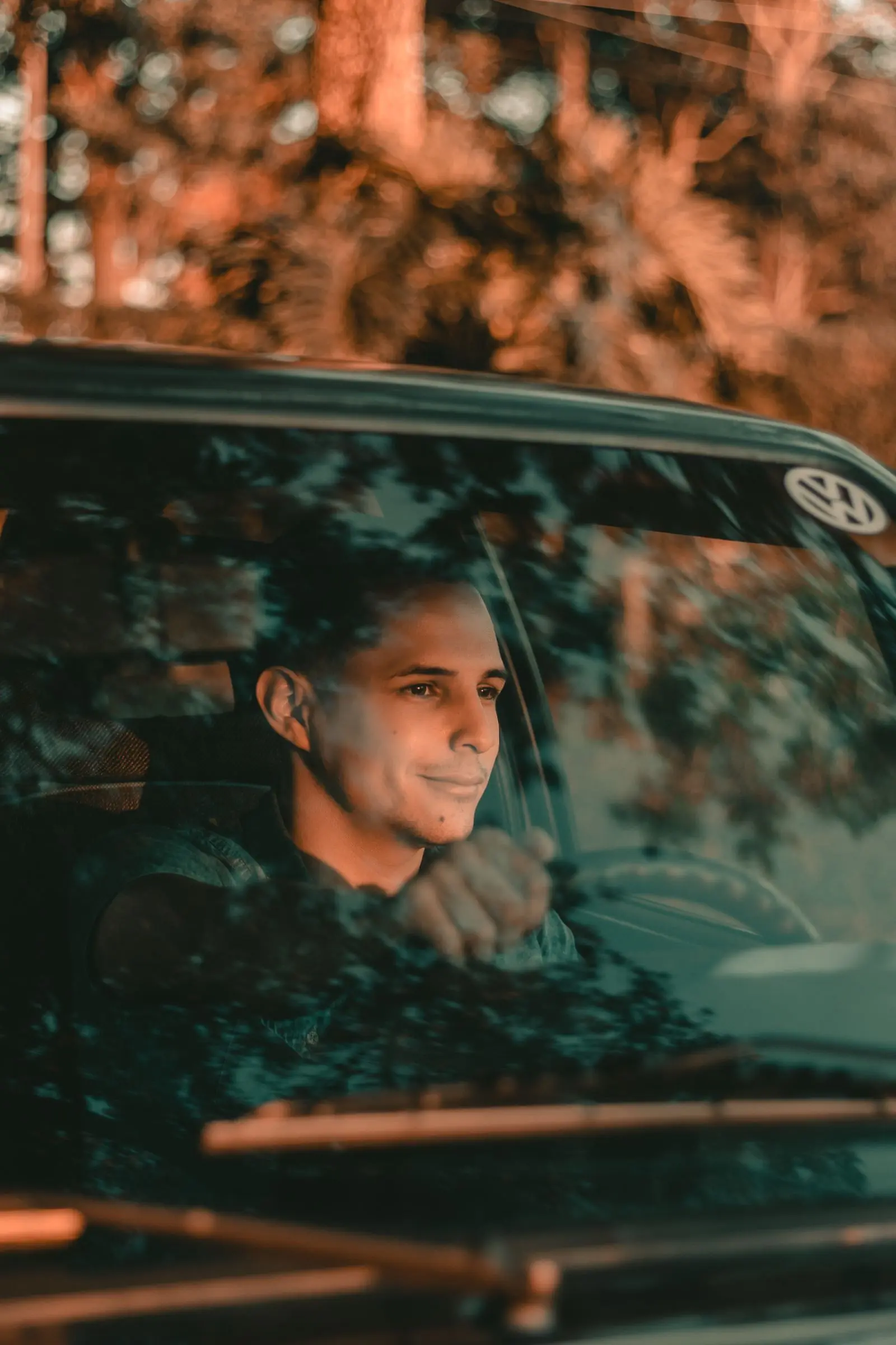 A smiling driver enjoying a calm lesson at sunset