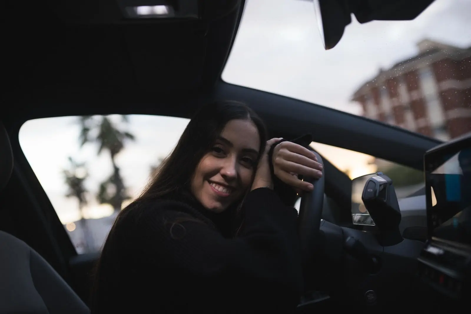 A learner smiling as she settles into the driver’s seat