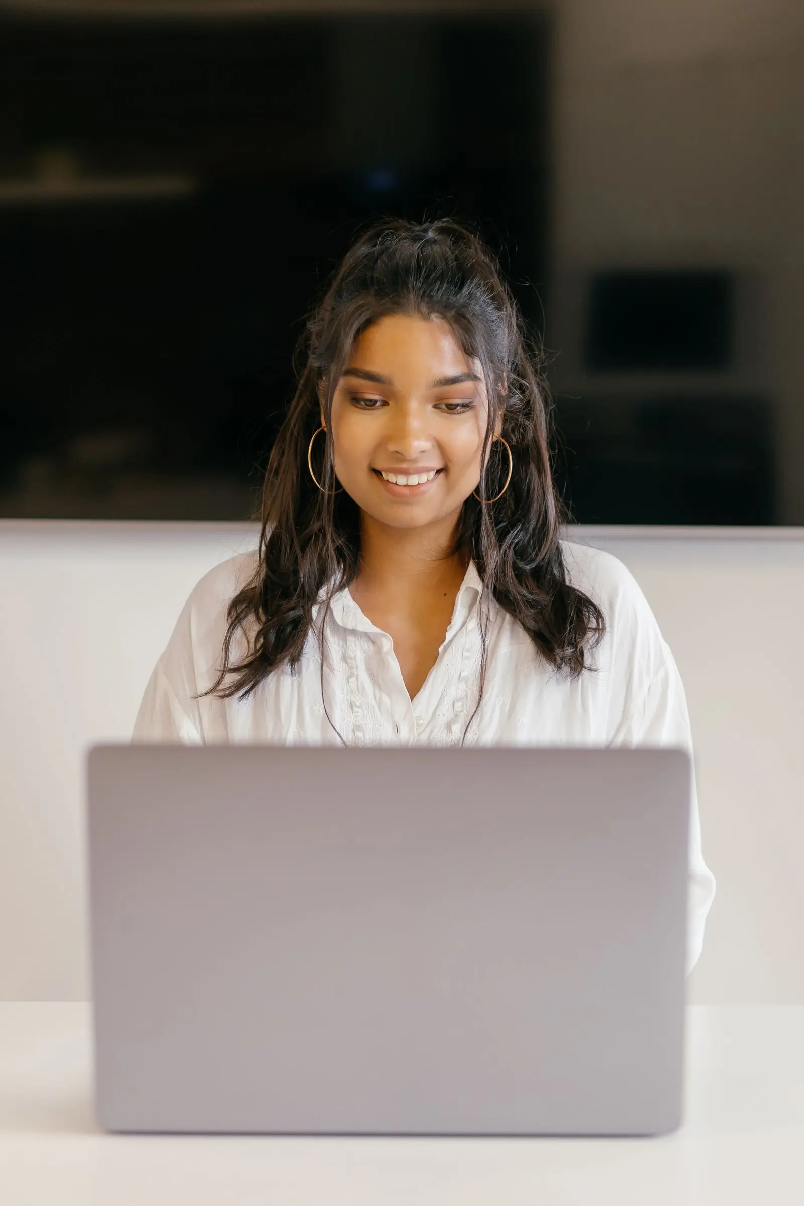 A teenage student working through an online course at a desk